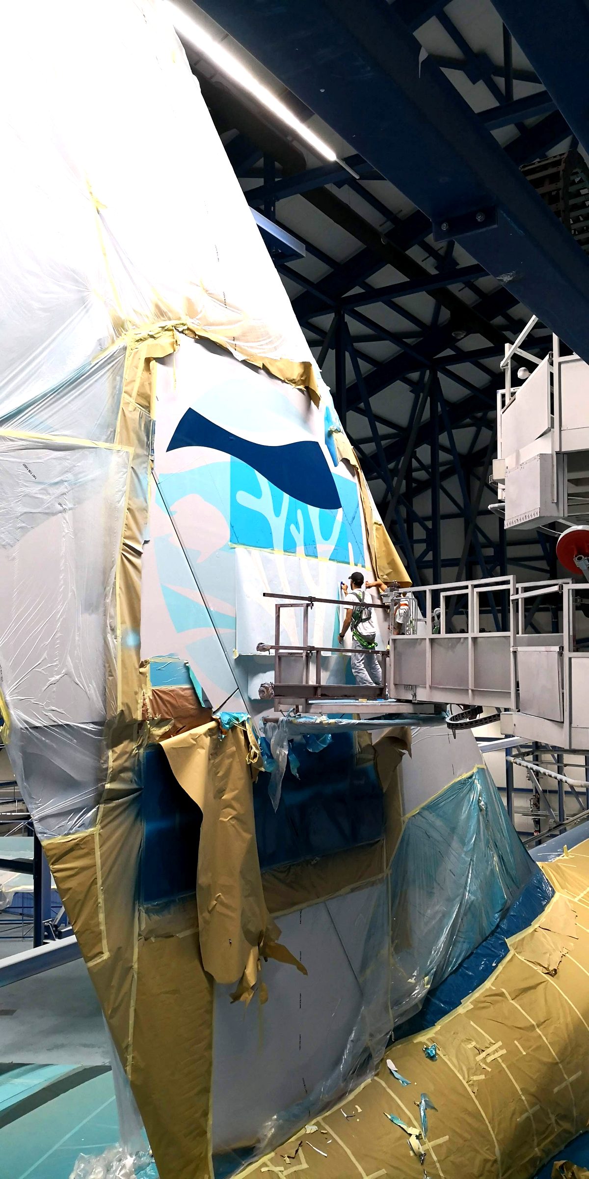 Applying spray masks on the masked A380 tail section